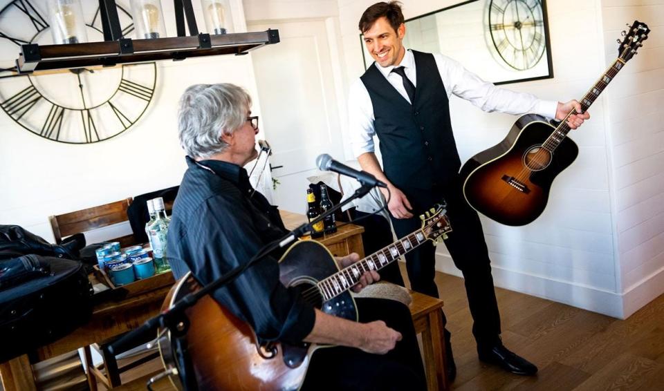 Jordan Jur (right) talks to guitarist Jeff Stevenson in Jur's Timnath home during his wedding reception Thursday, Dec. 22, 2022.