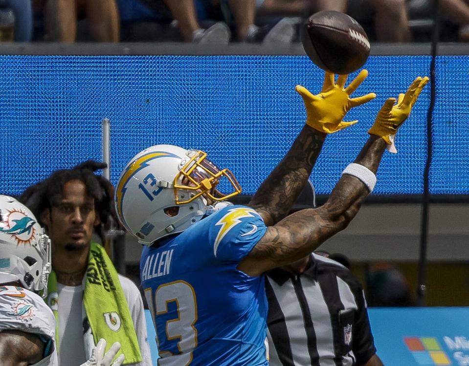 Chargers receiver Keenan Allen (13) hauls in a long pass against the Miami Dolphins at SoFi Stadium.