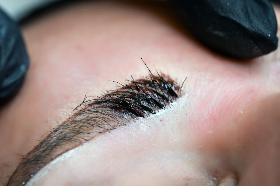 Microblading eyebrows, getting facial care and tattoo at beauty salon