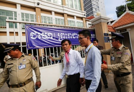 Uon Chhin and Yeang Sothearin, former journalists from the U.S.-funded Radio Free Asia (RFA), who have been charged with espionage, arrive at the Municipal Court of Phnom Penh for their verdict, in Phnom Penh