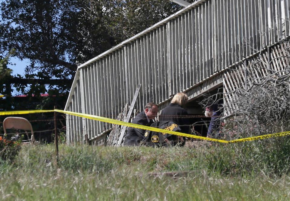 In this March 16, 2021, file photo, San Luis Obispo Sheriff's Office personnel dig in an area in the backyard of the home of Ruben Flores, in Arroyo Grande, Calif. Flores is the father of Paul Flores, who was the prime suspect in the disappearance of Kristin Smart in 1996.