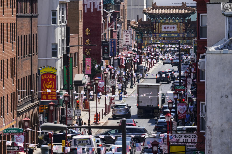 Traffic drives down 10th Street in the Chinatown neighborhood of Philadelphia, Friday, July 22, 2022. Organizers and members of Philadelphia's Chinatown say they were surprised by the 76ers' announcement that they hope to build a $1.3 billion arena just a block from the community’s gateway arch. (AP Photo/Matt Rourke)