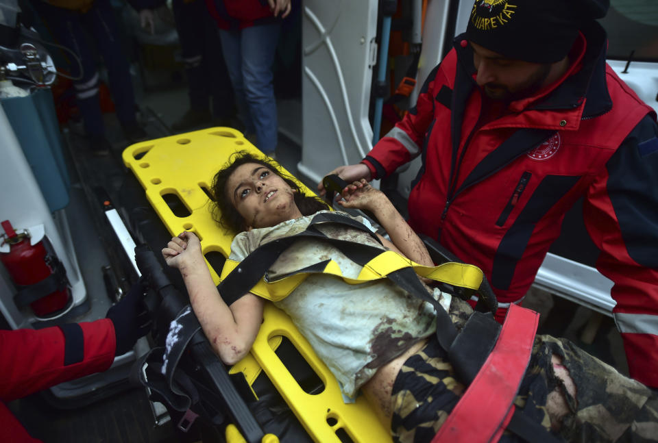 A rescuer takes care of a young girl rescued 4 days after the earthquake, in Kahramanmaras, southern Turkey, early Friday, Feb. 10, 2023. Rescuers have pulled more survivors from beneath collapsed buildings, but hopes were fading of finding many more people alive after the catastrophic earthquake in Turkey and Syria. (Ismail Coskun/IHA via AP)