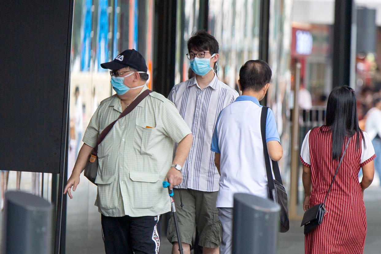 Two men seen wearing face masks outside the Funan Mall on Monday (27 January). (PHOTO: Dhany Osman / Yahoo News Singapore)