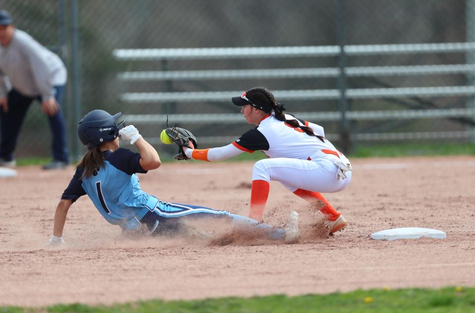 White Plains' Ava Galligani (3) works to put a tag on Ursuline's Jessica Tejera (1) during their 1-0 10th inning win  in softball action at White Plains High School  in White Plains on Saturday, April 16, 2022.