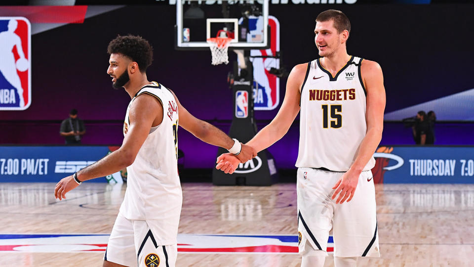 Jamal Murray and Nikola Jokic are pictured celebrating after the game.