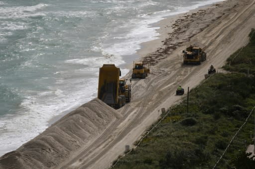 Heavy machinery dumping sand at Miami Beach shoreline in Miami Beach on January 17, 2020, opart of a plan to protect the beach from the effects of climate change and hurricanes