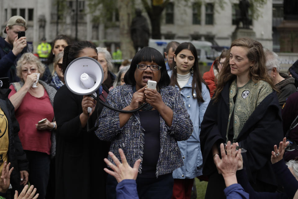 Britain's opposition Labour Party Shadow Home Secretary Diane Abbott addresses Extinction Rebellion climate change protesters on Parliament Square in central London, Wednesday, April 24, 2019. The non-violent protest group, Extinction Rebellion, is seeking negotiations with the government on its demand to make slowing climate change a top priority. (AP Photo/Matt Dunham)