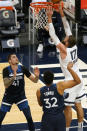 Memphis Grizzlies' Jonas Valanciunas (17) lays up a shot as Minnesota Timberwolves' Juancho Hernangomez (41) and Karl-Anthony Towns watch in the first half of an NBA basketball game, Wednesday, Jan. 13, 2021, in Minneapolis. (AP Photo/Jim Mone)