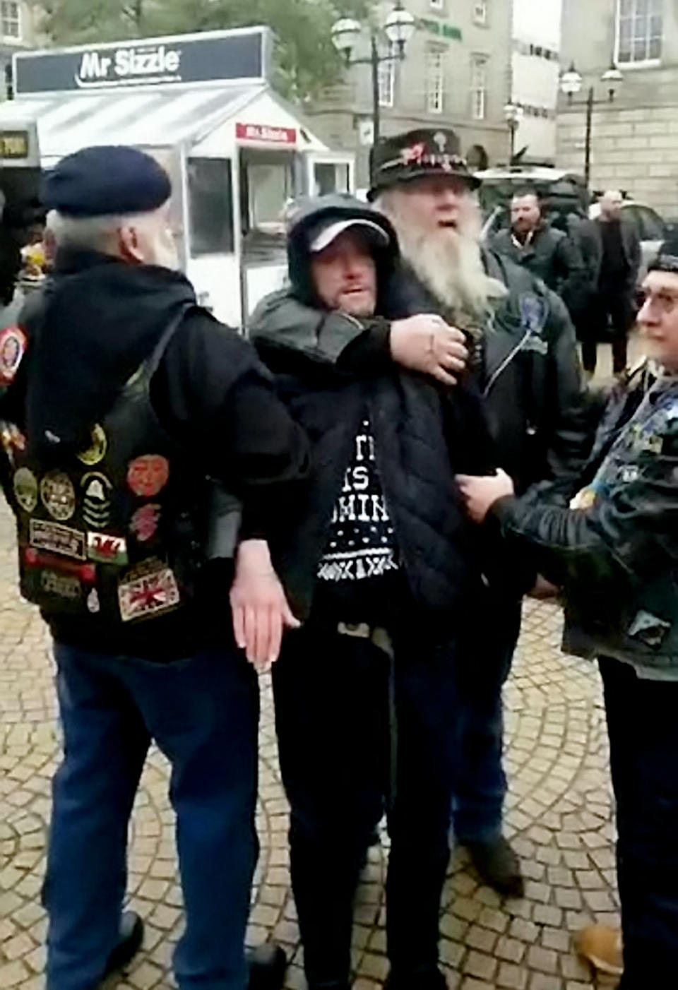 A terrified thief is held in a headlock by a bearded biker (Picture: SWNS)