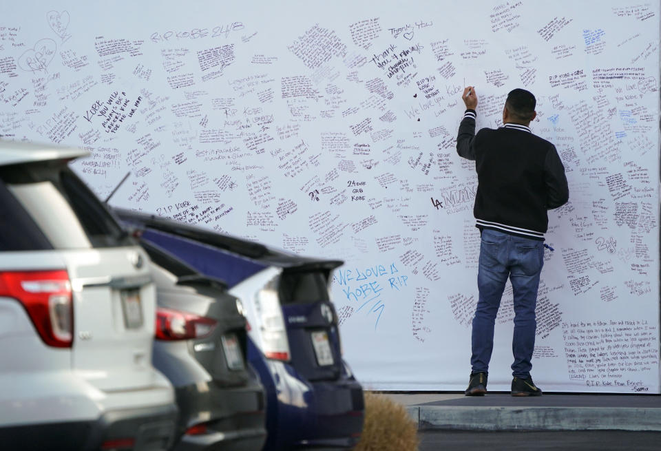 Employees and others with access to the UCLA Health Training Center sign messages to Kobe Bryant on a memorial wall at the Lakers practice facility in El Segundo on Monday, Jan. 27, 2020. The memorial is not accessible to the public. (Photo by Scott Varley/MediaNews Group/Torrance Daily Breeze via Getty Images)