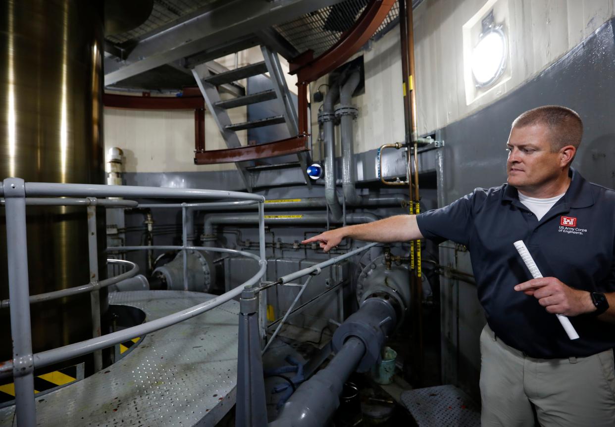 U.S. Army Corps of Engineers Chief Public Affairs Officer Jay Townsend talks about the power generation process in a room housing a shaft spinning at more than 100 RPM that links a turbine powered by water moving to a generator to make electricity at the Table Rock Dam on Wednesday, July 20, 2022.