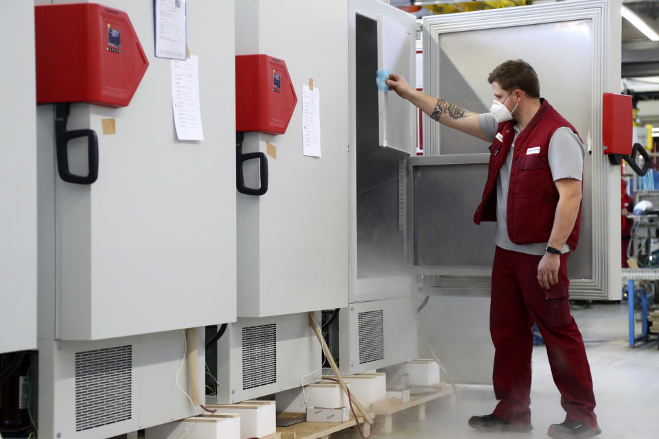 File -- In this Tuesday, Nov. 24, 2020 file photo an employee of Binder, the world's largest manufacturer of serial-production environmental simulation chambers for scientific or industrial laboratories, checks an ultra low temperature freezer in Tuttlingen, Germany. Germany prepares for the vaccination of the German population during the upcoming month. (AP Photo/Matthias Schrader, file)