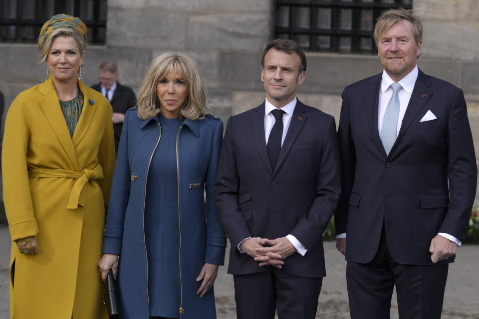 French President Emmanuel Macron, second right, his wife Brigitte Macron, second left, Dutch King Willem-Alexander and Queen Maxima,left, pose outside the royal palace on Dam square in Amsterdam, Netherlands, Tuesday, April 11, 2023. French President Emmanuel Macron begins a two-day state visit to the Netherlands on Tuesday and is making a speech on his vision for the future of Europe. (AP Photo/Peter Dejong)