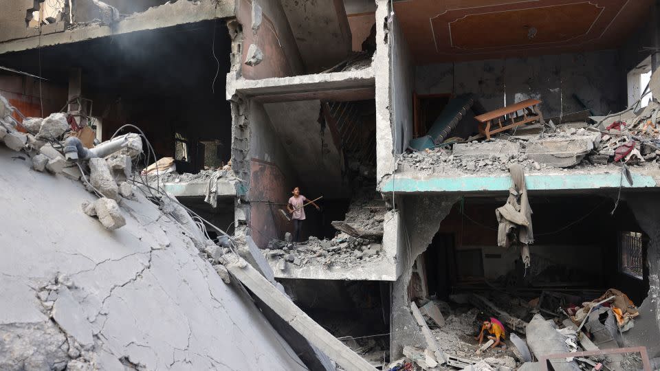 Palestinian children search through the rubble of their home a day after an operation by Israeli Special Forces in the Nuseirat camp, in the central Gaza Strip, on June 9, 2024. - Eyad Baba/AFP/Getty Images