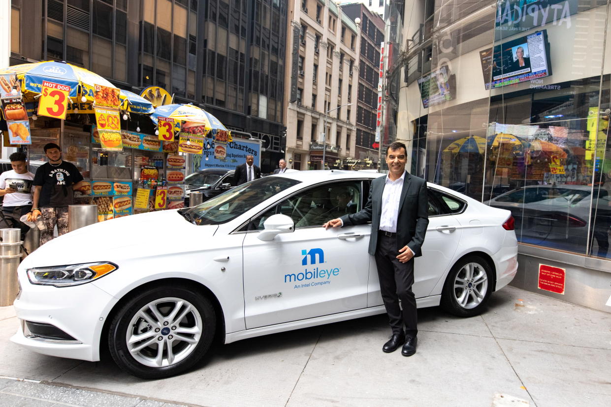 Mobileye’s CEO Amnon Shashua poses with a Mobileye driverless vehicle at the Nasdaq Market site in New York, U.S., July 20, 2021. REUTERS/Jeenah Moon