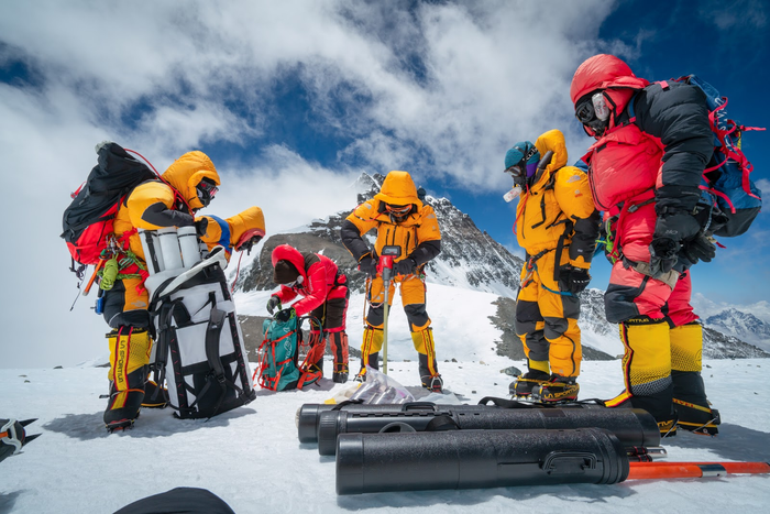 Mariusz Potocki and sherpa team drilling the highest ice core ever recovered at 8020 meters of elevation with the summit of Mount Everest in the background.  / Credit: Dirk Collins, National Geographic