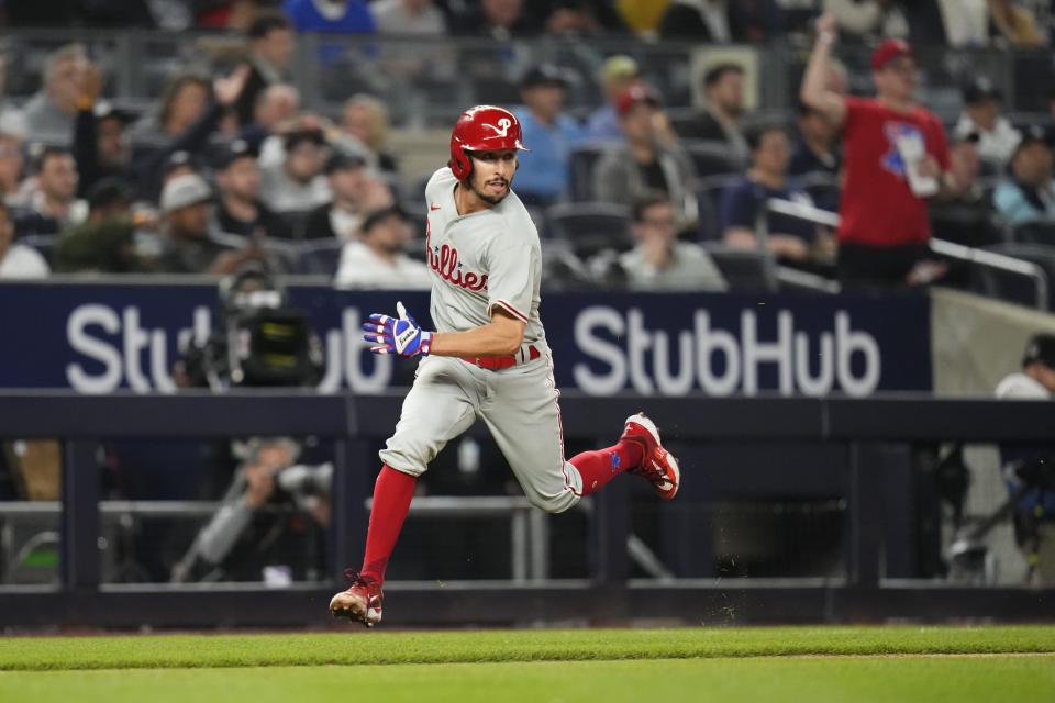 Philadelphia Phillies' Garrett Stubbs runs toward home plate to score on a single by Kyle Schwarber during the fifth inning of the team's baseball game against the New York Yankees on Tuesday, April 4, 2023, in New York. (AP Photo/Frank Franklin II)