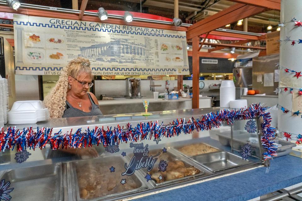 Angie gets food trays ready in the Grecian Garden Rstaurant, Friday, Aug. 11, 2023 in City Market. The restaurant lease has not been renewed and the business is moving out.