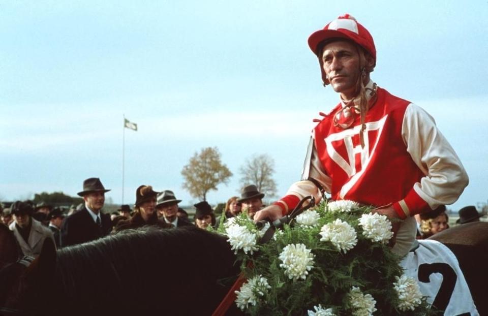 Stevens atop a horse as a jockey in the film