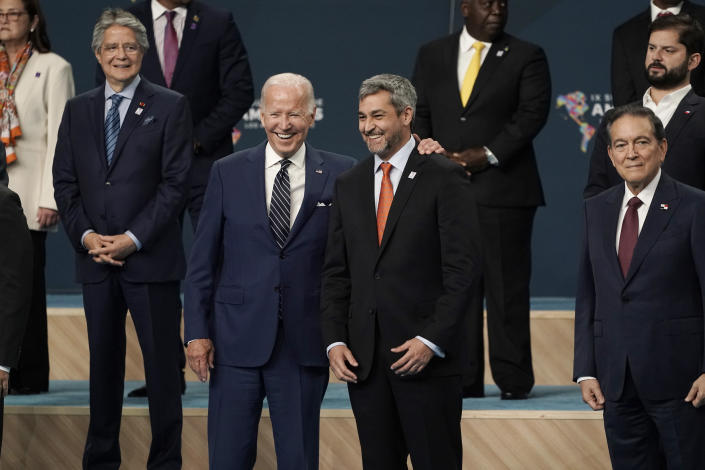 President Joe Biden puts his arm around Paraguay President Mario Abdo Benitez as they participate in a family photo with heads of delegations at the Summit of the Americas, Friday, June 10, 2022, in Los Angeles. (AP Photo/Jae C. Hong)