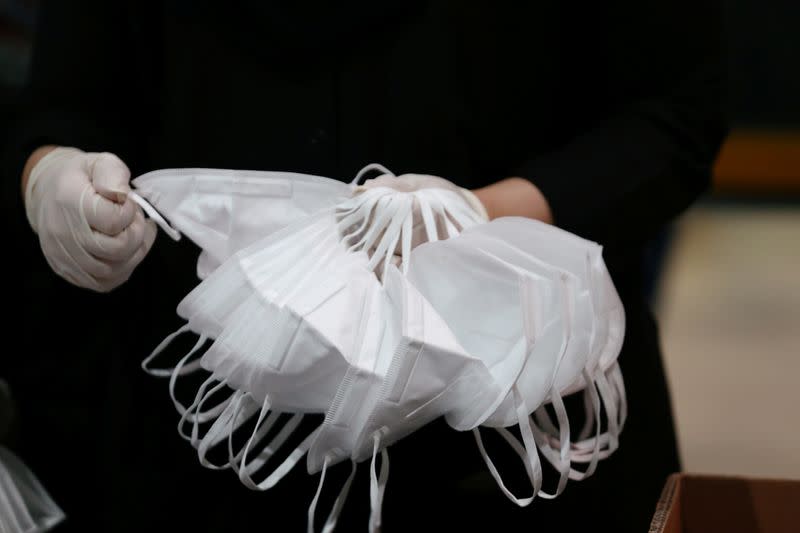 A worker sorts through N95 masks, made at the Strata Manufacturing facility, in Al Ain