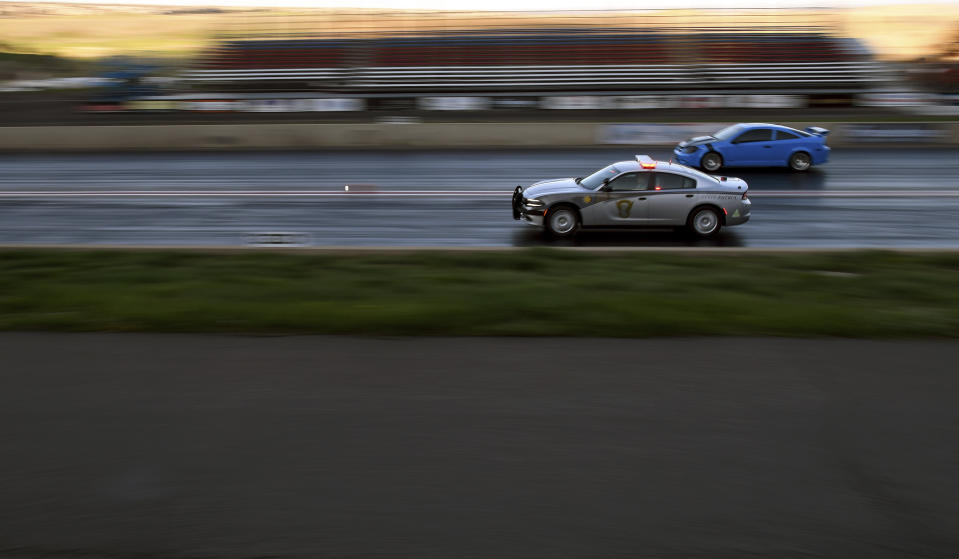 Colorado State Patrol Trooper Josh Lewis races at Bandimere Speedway west of Denver on Wednesday, May 5, 2021. The State Patrol runs a program called "Take it to the Track" in hopes of luring racers away from public areas to a safer and more controlled environment. The program's goals have gained new importance and urgency this year as illegal street racing has increased amid the coronavirus pandemic. (AP Photo/Thomas Peipert)