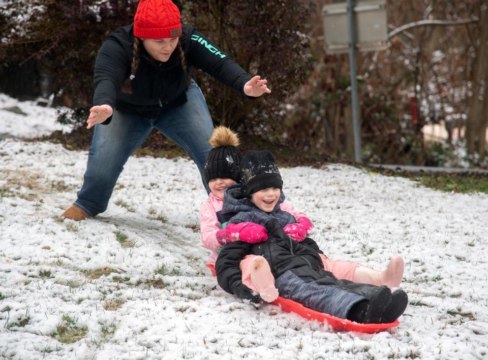 Four-year-old Zara Whited and 5-year-old Eli Whited of Angels Camp are pushed down a snow covered hill on a sled by their nanny Hailey Smith Jan. 25, 2021, at Uttica Park in Angels Camp.