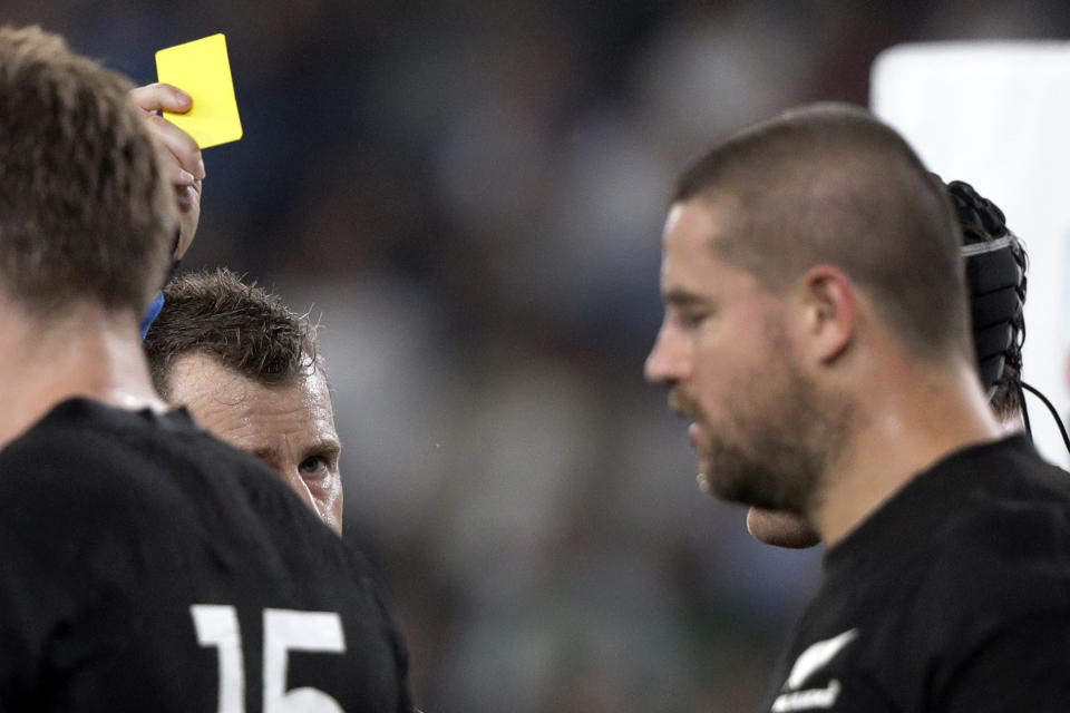 Referee Nigel Owens shows yellow card to New Zealand's Matt Todd during the Rugby World Cup quarterfinal match at Tokyo Stadium between New Zealand and Ireland in Tokyo, Japan, Saturday, Oct. 19, 2019. (AP Photo/Mark Baker)