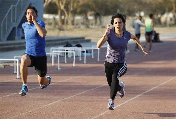 Iraqi sprinter Dana Abdul-Razzaq (R) during a training session in Baghdad University, February 27, 2012.