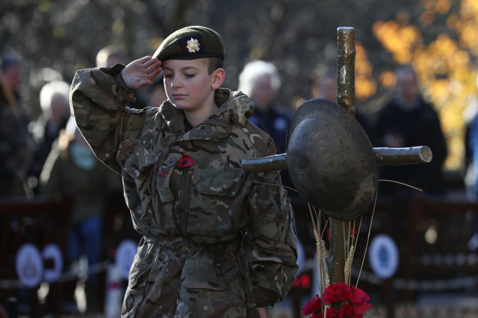 <p>Scots Guards Army Cadet Force member Nathan Skinner, 13, salutes in memory of those who have fallen in conflict, following a service of Remembrance at the Edinburgh Garden of Remembrance in East Princes Street Gardens, Edinburgh. (Photo: Andrew Milligan/PA Images via Getty Images) </p>