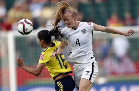 Jun 22, 2015; Edmonton, Alberta, CAN; United States defender Becky Sauerbrunn (4) and Colombia forward Lady Andrade (16) go for a head ball during the second half in the round of sixteen in the FIFA 2015 women's World Cup soccer tournament at Commonwealth Stadium. Mandatory Credit: Michael Chow-USA TODAY Sports