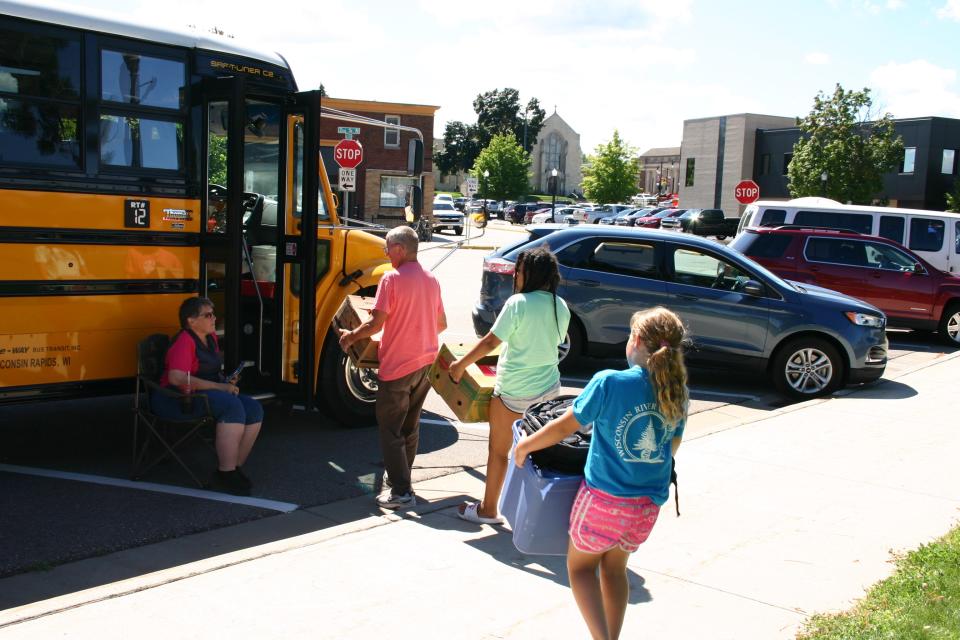 Volunteers load school supplies onto a bus Aug. 4 during the United Way of South Wood & Adams Counties' Stuff the School Bus collection event. Last year, the organization had 600 registrations for their program, and this year that number nearly doubled, with 1,050 students seeking help.