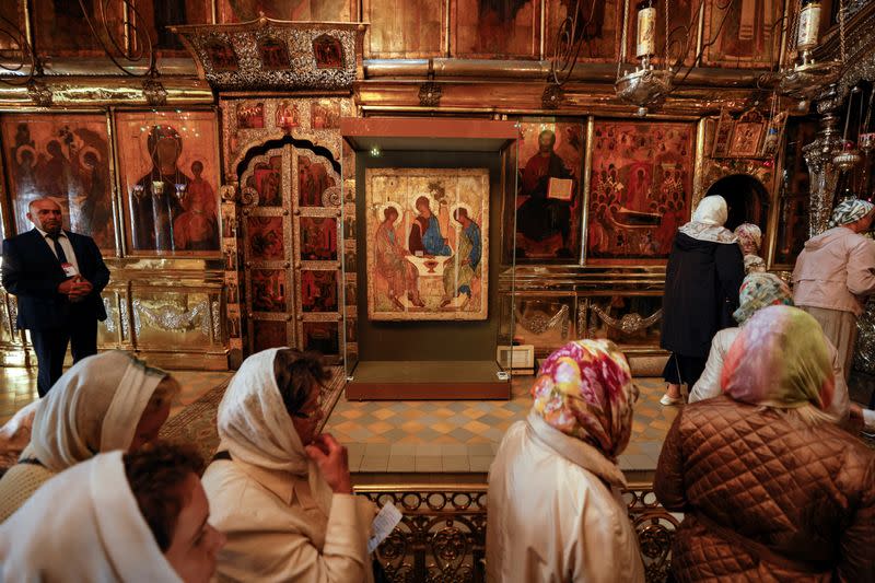 Believers gather near the Trinity icon at a cathedral in Sergiyev Posad