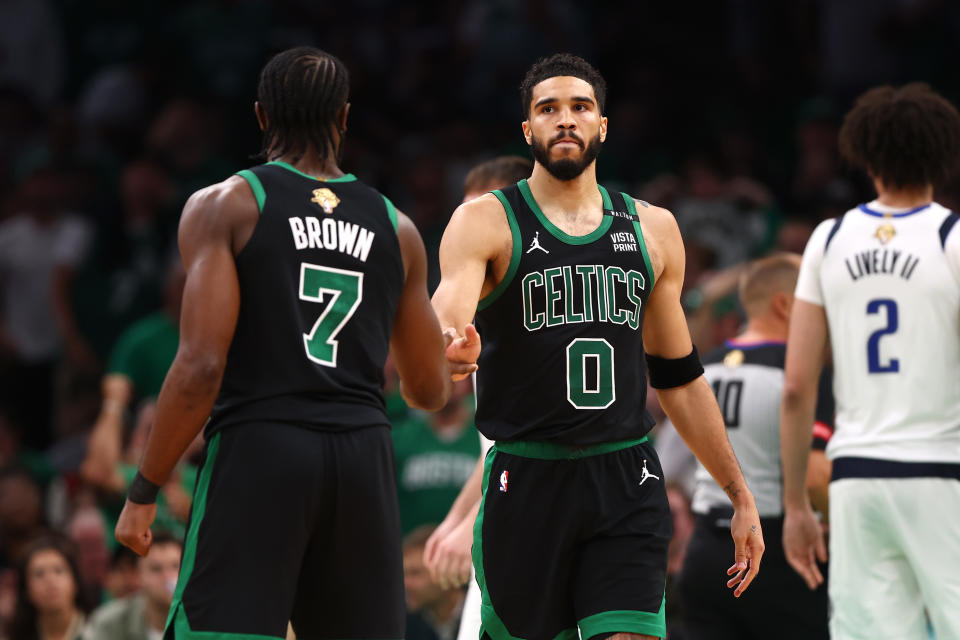 BOSTON, MASSACHUSETTS - JUNE 09: Jayson Tatum #0 and Jaylen Brown #7 of the Boston Celtics high give during the third quarter against the Dallas Mavericks in Game Two of the 2024 NBA Finals at TD Garden on June 9, 2024 in Boston, Massachusetts.  NOTE TO USER: User expressly acknowledges and agrees that by downloading and/or using this photo, user agrees to the terms and conditions of the Getty Images License Agreement.  (Photo by Maddie Meyer/Getty Images)