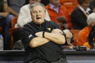 FILE- In this Jan. 6, 2020, file photo, West Virginia head coach Bob Huggins reacts during an NCAA college basketball game against Oklahoma State in Stillwater, Okla. College coaches endured a tense time waiting for for the NCAA to green light the 2020 basketball season. They knew there was a window the NCAA was looking at to start the season, likely sometime in late November or early December. They just didn't have an exact date. So they did the best they could to prepare for the big moment, yet still found themselves in a scramble once it actually happened. (AP Photo/Sue Ogrocki, File)