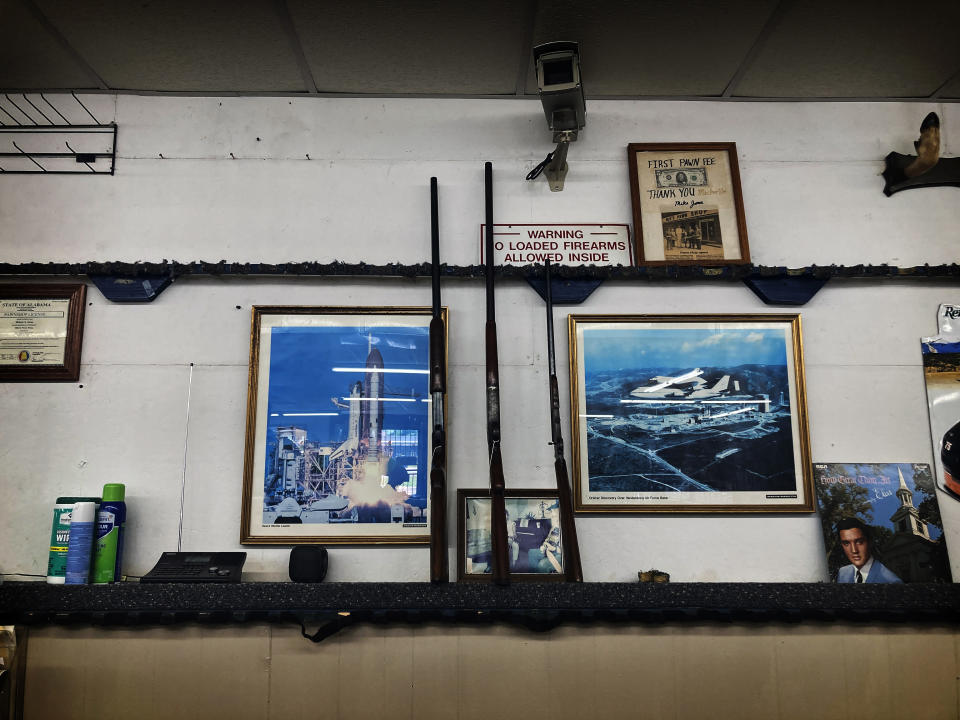 Guns are on display at Mike's Pawn shop in Moulton, Ala., on Friday, June 24, 2022. (AP Photo/Brynn Anderson)