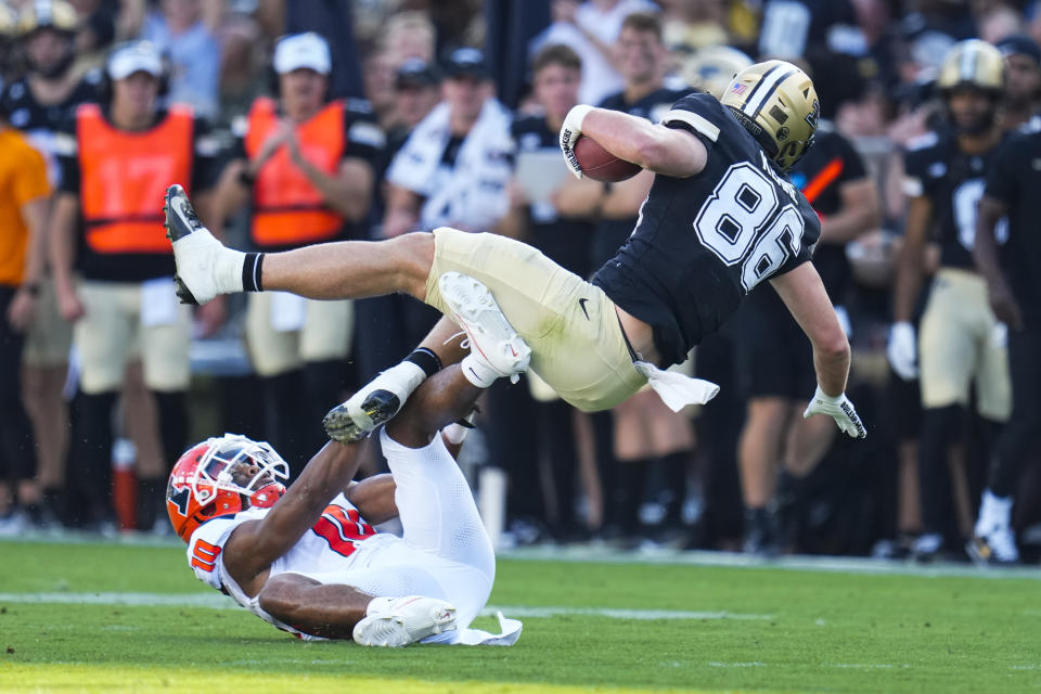 Purdue tight end Max Klare (86) is upended by Illinois defensive back Miles Scott (10) during the first half of an NCAA college football game in West Lafayette, Ind., Saturday, Sept. 30, 2023. (AP Photo/Michael Conroy)