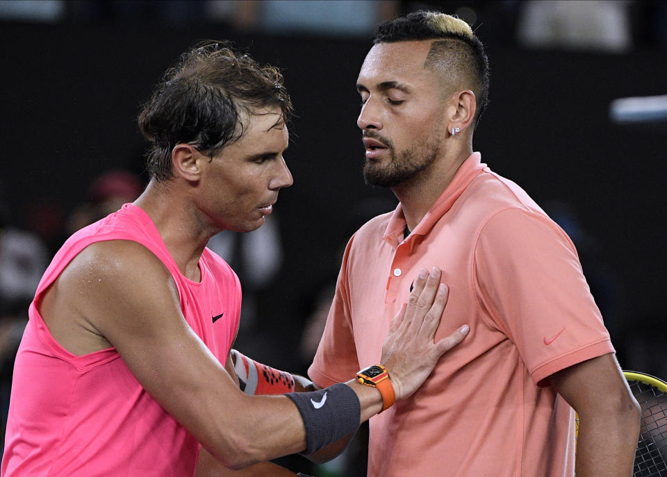 Spain's Rafael Nadal, left, is congratulated by Australia's Nick Kyrgios after winning their fourth round singles match at the Australian Open tennis championship in Melbourne, Australia, Monday, Jan. 27, 2020. (AP Photo/Andy Brownbill)