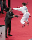 Egypt's Yassmin Attia (L) celebrates with her coach after beating Malaysia's Nisha Alagasan to take bronze medal in the Female Kumite under 55Kg category of the world karate championships on November 24, 2012 in Paris. AFP PHOTO/JACQUES DEMARTHON