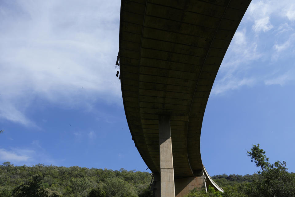 A view of a bridge over a ravine where a bus plunged onto a mountain pass on Thursday, in the Limpopo Province, South Africa., Friday, March 29, 2024. Authorities say a bus carrying worshippers headed to an Easter weekend church gathering plunged off a bridge on a mountain pass and burst into flames in South Africa, killing at least 45 people. The only survivor of Thursday's crash was an 8-year-old child, who was receiving medical attention. (AP Photo/Themba Hadebe)