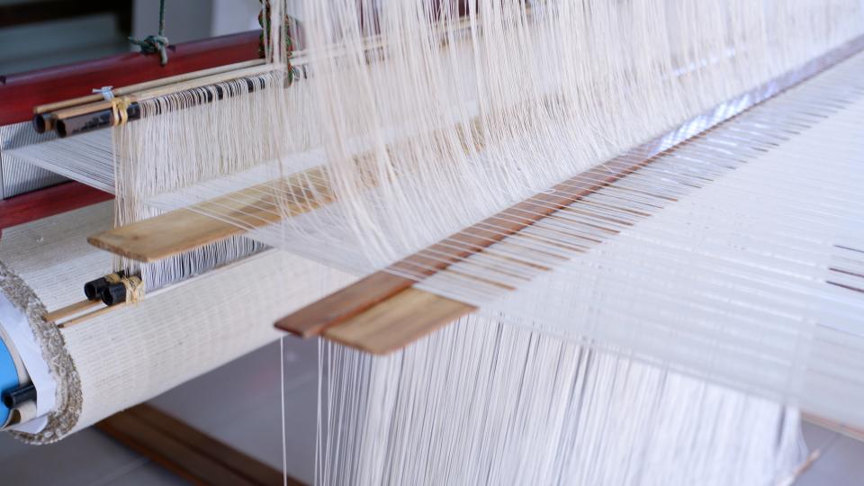 The designer is setting up looms in Laos to develop textiles for his home decor collection.