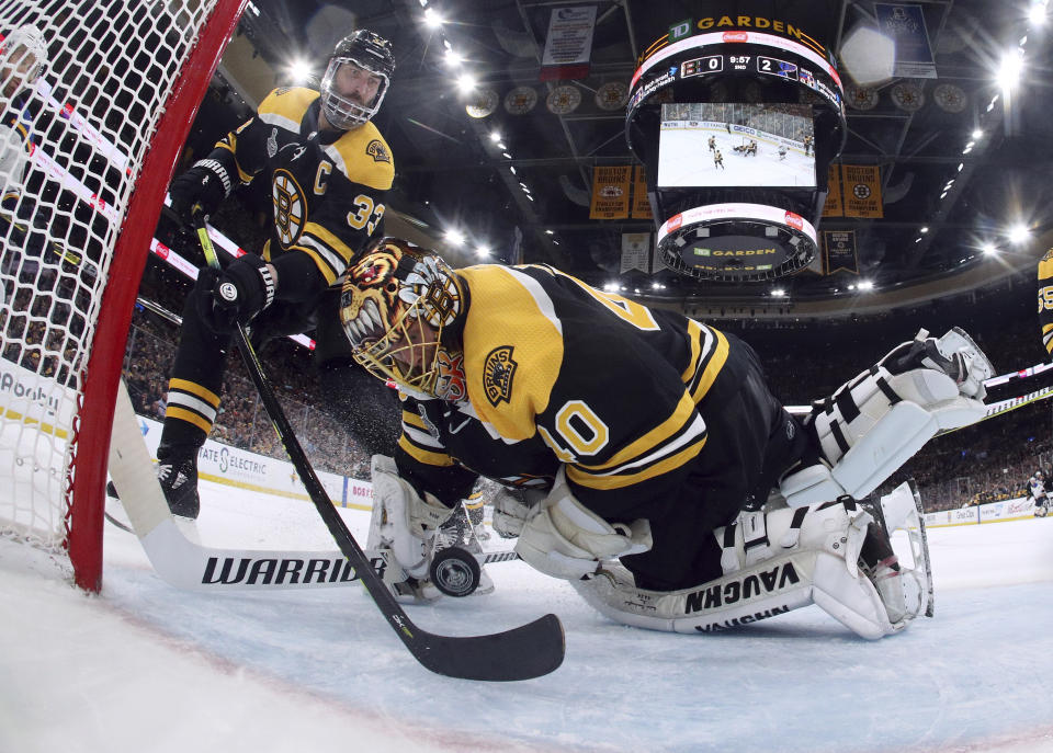 Boston Bruins' Zdeno Chara, left, of Slovakia, reaches behind goaltender Tuukka Rask, of Finland, to keep the puck from crossing the goal line during the second period in Game 7 of the NHL hockey Stanley Cup Final against the St. Louis Blues, Wednesday, June 12, 2019, in Boston. (Bruce Bennett/Pool via AP)