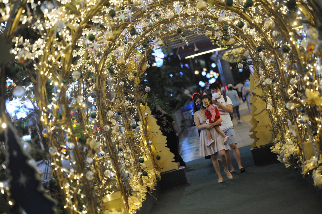 People taking photos with the Christmas along the shopping belt of Orchard Road on 16 December. (PHOTO: Getty Images)