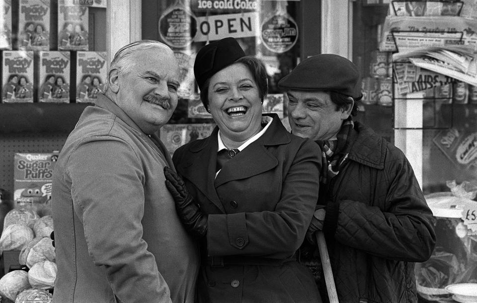 Television's favourite tight-fisted shopkeeper, A E Arkwright, who is Ronnie Barker, with co-stars Lynda Baron (Nurse Gladys) and David Jason (Arkwright's nephew/assisstant Granville) outside the shop during a break in filming Open All Hours in Doncaster.   (Photo by PA Images via Getty Images)