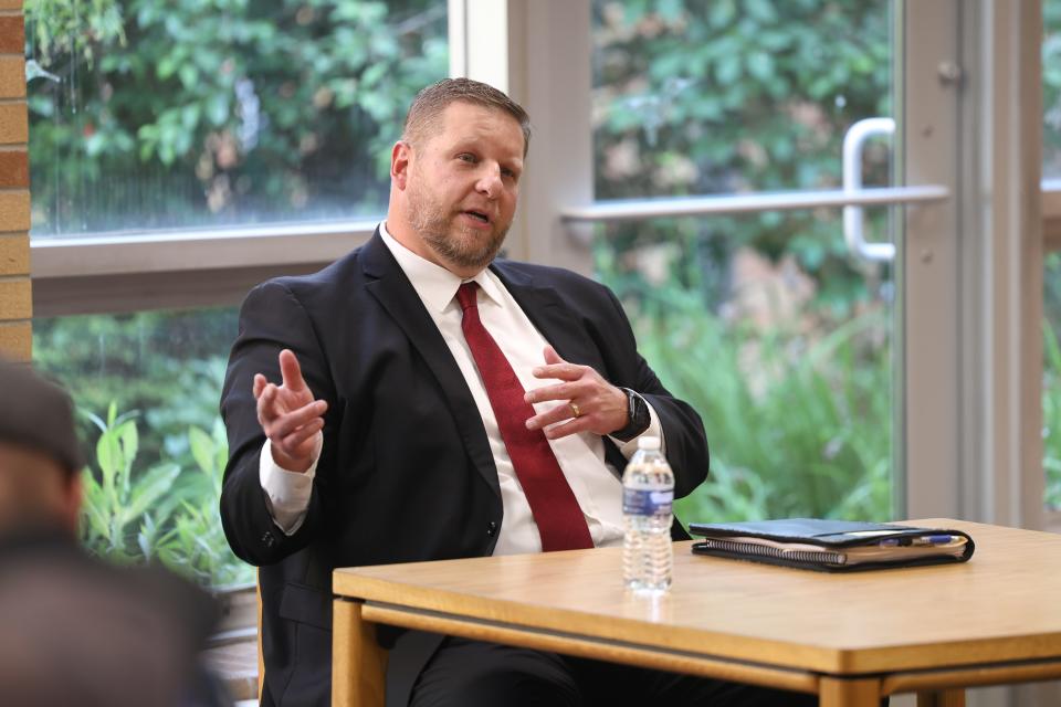 Candidate for Kent City Schools superintendent and current Director of Student Services for the district, Justin Gates, speaks to community members and school staff at a candidate forum Tuesday, June 6, 2023 at Kent Roosevelt High School.