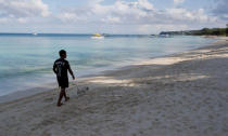 A resident walks his dog in an empty beach during the shutdown of the holiday island Boracay, in Philippines April 26, 2018. REUTERS/Erik De Castro