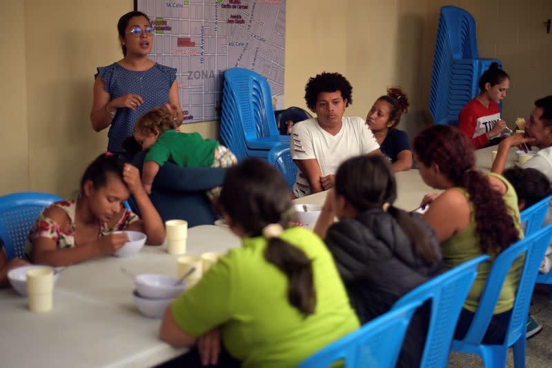 FILE PHOTO: Honduran migrants, sent back to Guatemala from the U.S., sit at the table after arriving at Casa del Migrante shelter in Guatemala City