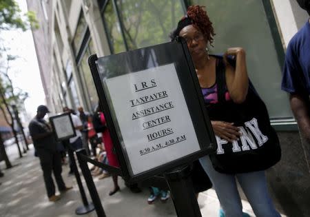 People wait outside the Internal Revenue Service office in the Brooklyn borough of New York May 27, 2015. REUTERS/Shannon Stapleton