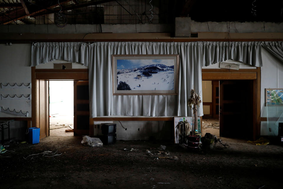 <p>A poster of the snow-covered resort hangs on a wall at the abandoned Alps Ski Resort located near the demilitarized zone separating the two Koreas in Goseong, South Korea, Jan. 17, 2018. (Photo: Kim Hong-Ji/Reuters) </p>